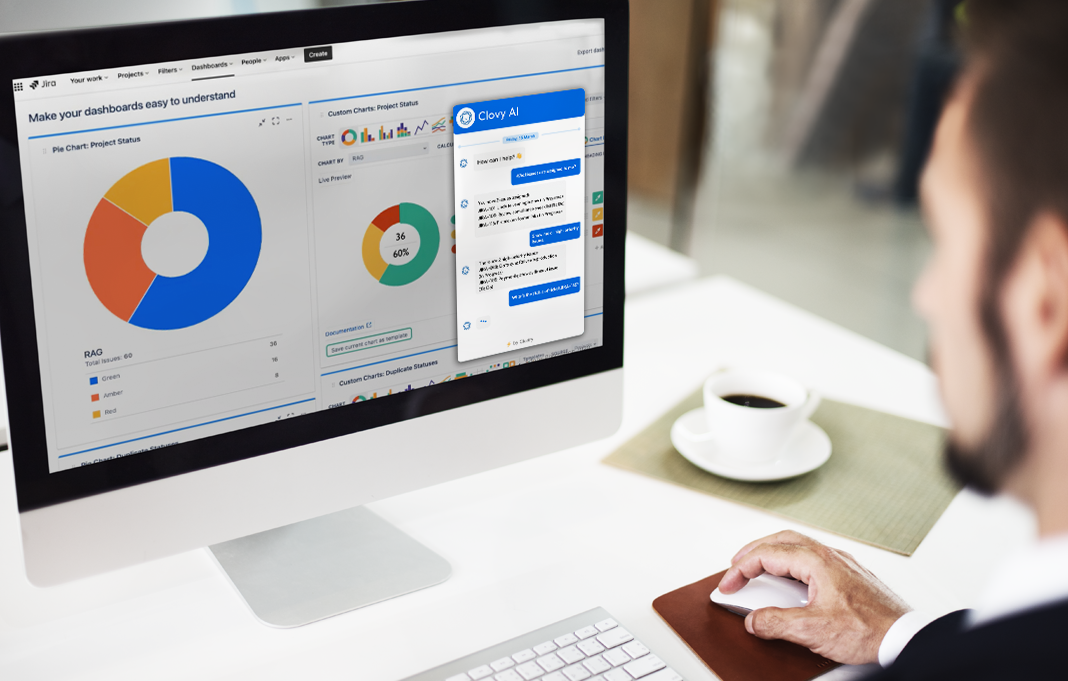 Desktop computer showing IT service management dashboard with charts and a chat window, with a man using a mouse in the foreground